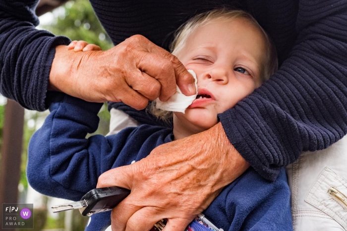 North Rhine-Westphalia Grandma cleaning kids nose during a Dusseldorf family photo session