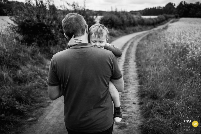 Photo by: <a href="https://www.fpja.com/documentary-family-photography-contests/andy-hudson/county-durham/2108708">Andy Hudson - United Kingdom</a> County Durham Sleepy little boy being carried home in a England family photo session outdoors