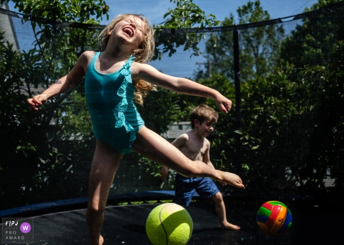 Germany kids playing A hot summer's day at home on the trampoline in this Berlin family photo Germany kids playing A hot summer's day at home on the trampoline in this Berlin family photo