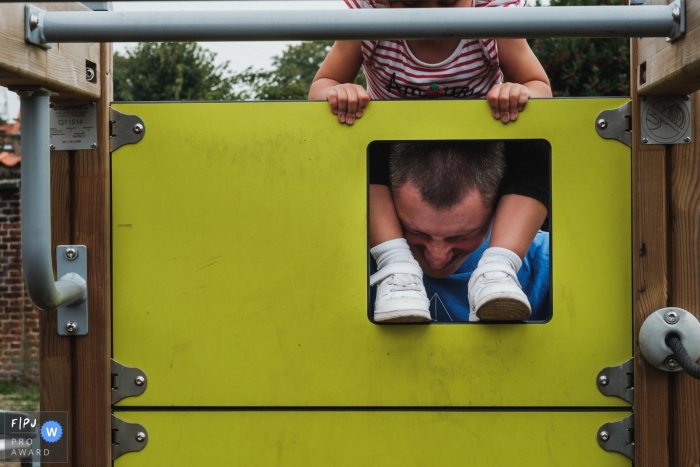 Photo by: <a href="https://www.fpja.com/documentary-family-photography-contests/christophe-de-mulder/antwerpen/2108894">Christophe De Mulder - Belgium</a> Antwerpen documentary-style family fun photography session in Belgium of a dad taking some suffering while he plays with his daughter at the playground