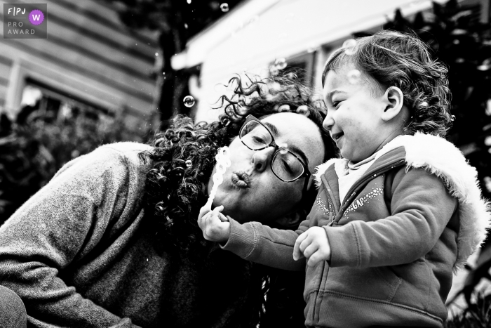 Black and white outdoor DC family pictures from an at-home photo shoot - let's blow bubbles together