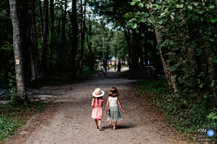 Photo by: <a href="https://www.fpja.com/documentary-family-photography-contests/sylvain-garderes/nouvelle-aquitaine/2109583">Sylvain Garderes - France</a> France Family photographer captures two little girls walking down a tree-lined trail