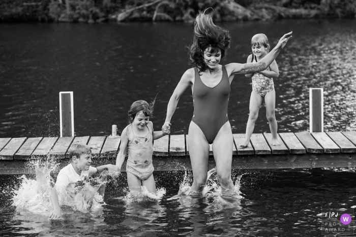 Seattle Family Photographer documented a family jump into the lake off a dock Seattle Family Photographer documented a family jump into the lake off a dock