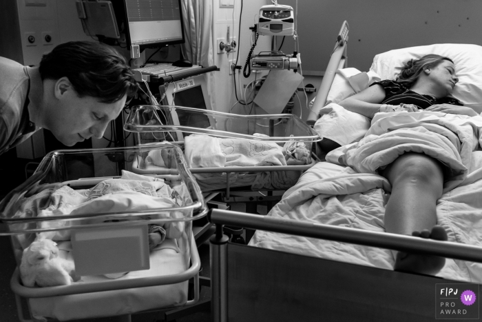 Photo by: <a href="https://www.fpja.com/documentary-family-photography-contests/louise-van-den-broek/flevoland/2110416">Louise van den Broek - Netherlands</a> Isala hospital documentary birth photography showing Mom is out after a exhausting c-section while dad can't stop looking at his girls