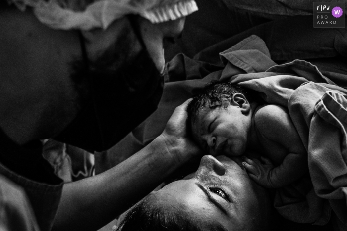 Sao Paulo hospital natural birth photo of the Mother looking for the father of their son