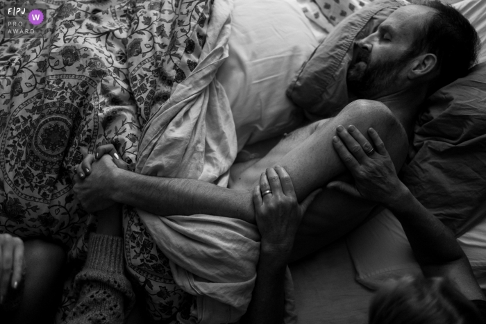 Photo by: <a href="https://www.fpja.com/documentary-family-photography-contests/benjamin-lipford/atlanta/2110401">Benjamin Lipford - United States</a> Atlanta at-home Day in the Life photography of a mother and child praying over the father's illness