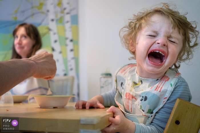 Photo by: <a href="https://www.fpja.com/documentary-family-photography-contests/jess-haverkamp/berlin/2110530">Jess Haverkamp - Germany</a> Berlin Day in the Life documentary family photo of A 2 year old boy protesting dinner