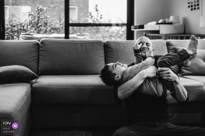 Day in the Life Belgium documentary family photography session with Dad and son playing together Day in the Life Belgium documentary family photography session with Dad and son playing together