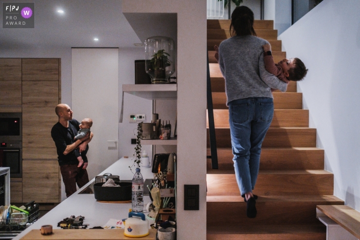 Antwerp Day in the Life Session of documentary family photography showing Mom and the oldest child go upstairs, while dad and the youngest stay downstairs