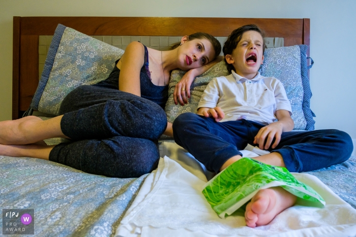 Day in the Life photography session at home in Sao Paulo with a boy hurting sitting with his mom