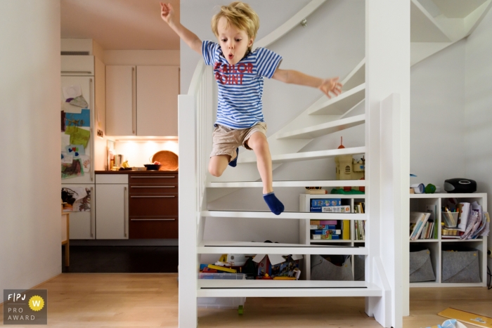 Day in the Life Zuid Holland documentary family photography session showing the Boy is jumping off the stairs Day in the Life Zuid Holland documentary family photography session showing the Boy is jumping off the stairs