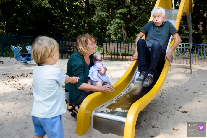South Holland Day in the Life documentary family photo showing off Best friend grandpa playing on a kids slide South Holland Day in the Life documentary family photo showing off Best friend grandpa playing on a kids slide