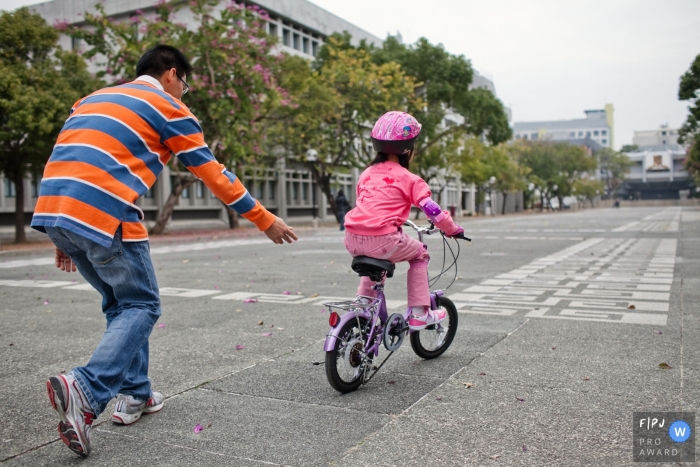 Photo by: <a href="https://www.fpja.com/documentary-family-photography-contests/chris-shum/san-francisco/2111565">Chris Shum - United States</a> San Francisco at home Day in the Life photography capturing a girl riding a bike on two wheels for the first time