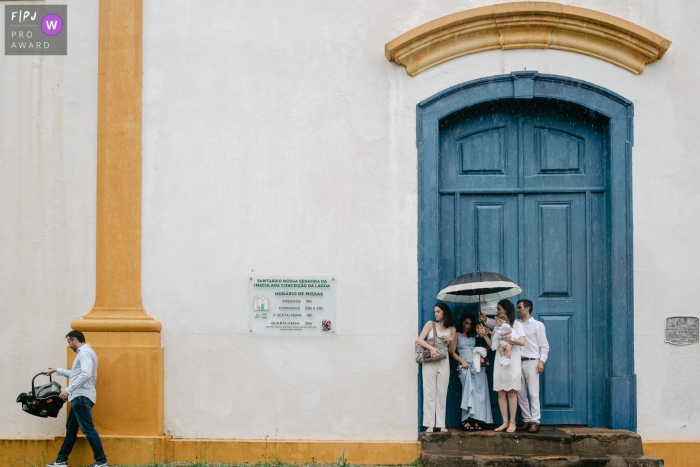 Florianopolis, Santa Catarina documentary family photography of a family waiting at the church door on a baptism day with a lot of rain 