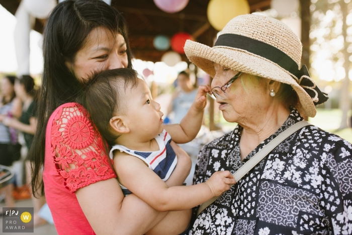 Los Angeles Day in the Life Session of documentary family photography showing a toddler grabs grandma's glasses off her face