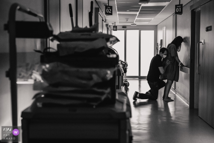 Moment-driven Hospital Albert Einsten birth photography of a couple helping each other during labor