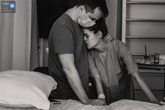 Moment-driven Hospital Albert Einsten birth photography of a husband comforting his wife during her labor Moment-driven Hospital Albert Einsten birth photography of a husband comforting his wife during her labor