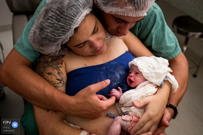 Moment-driven Hospital Sepaco birth photography from the first look of the new baby for mom and dad