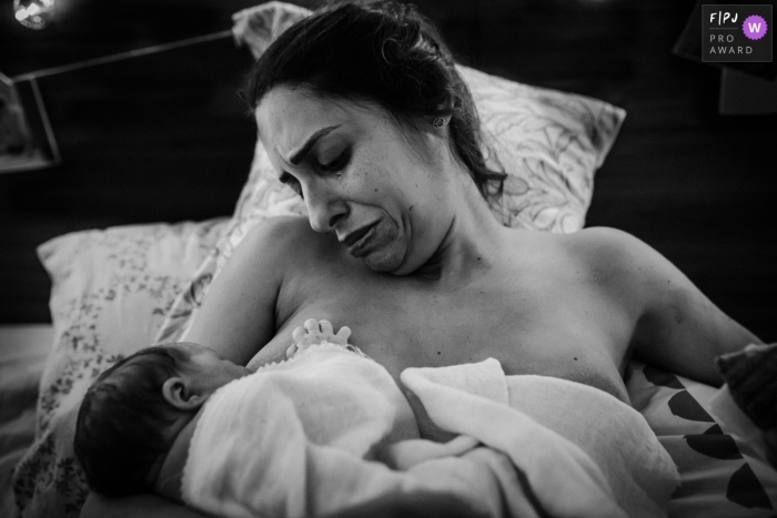 Moment-driven at-home birth photography illustrating The thrill of having your daughter in your arms