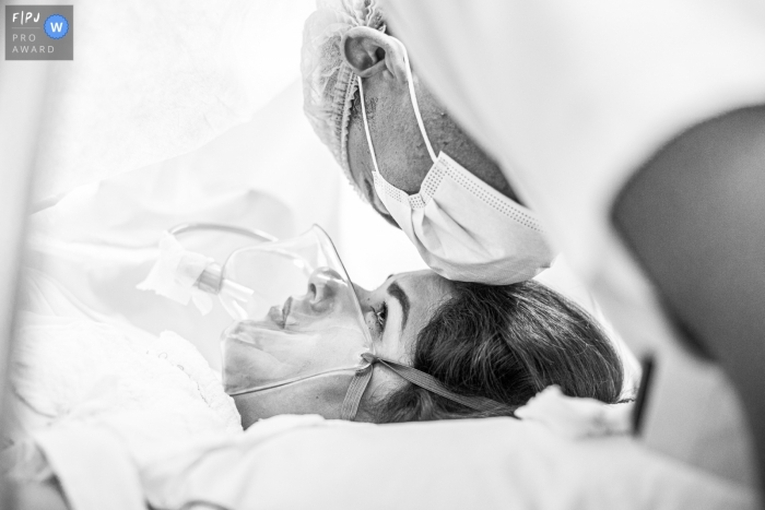 Moment-driven Rio de Janeiro birth photography in BW showing wife with fear looking in husband eyes Moment-driven Rio de Janeiro birth photography in BW showing wife with fear looking in husband eyes