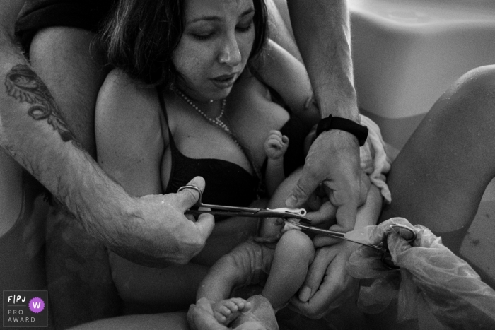 Moment-driven Hospital Santa Rosa birth photography of the Cutting the umbilical cord Moment-driven Hospital Santa Rosa birth photography of the Cutting the umbilical cord