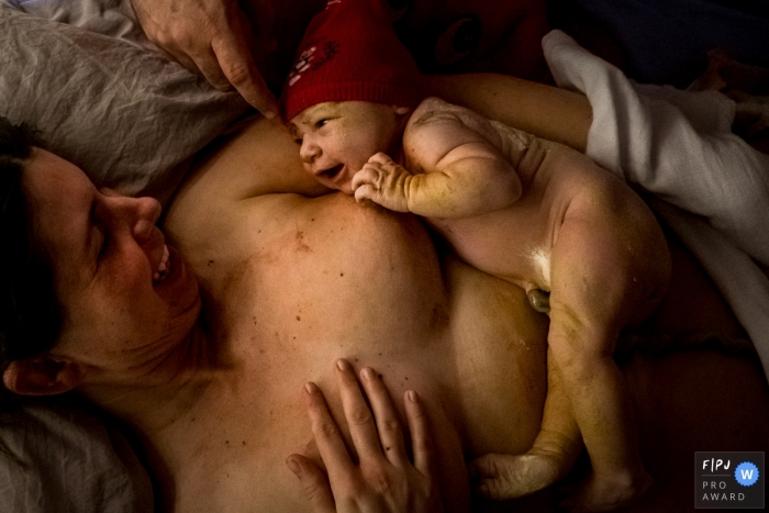 Moment driven Sao Paulo birth photojournalism image capturing the first imprinting of baby and mom Moment driven Sao Paulo birth photojournalism image capturing the first imprinting of baby and mom
