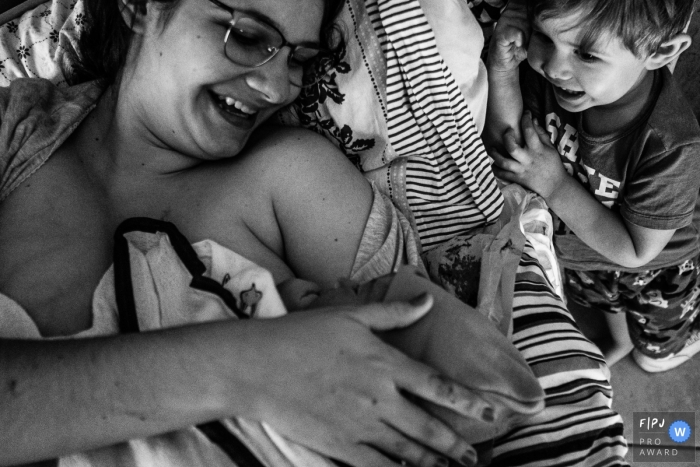 Moment-driven SP, Brazil birth photography showing The older brother's curiosity and emotion when meeting his younger brother Moment-driven SP, Brazil birth photography showing The older brother's curiosity and emotion when meeting his younger brother