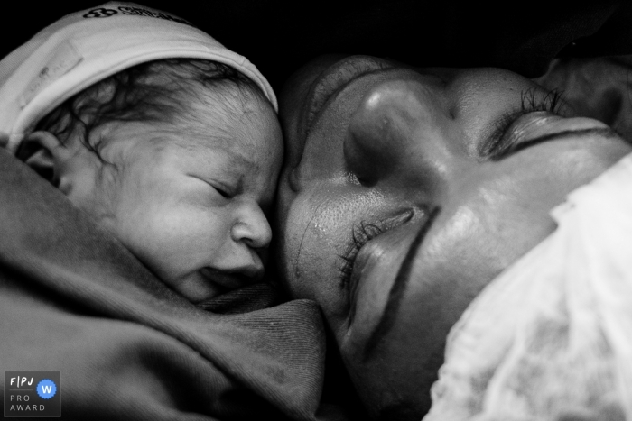 Moment-driven Maternidade Santa Helena birth photography capturing the Meeting of mother and daughter, at the golden hour