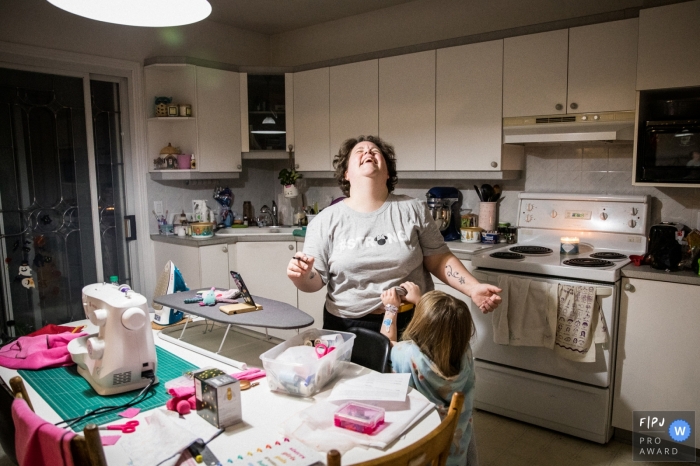 Photo by: <a href="https://www.fpja.com/documentary-family-photography-contests/anabel-burin/montreal/2112056">Anabel Burin - Canada</a> Montreal family photography. This image is a part of a series I did on single mother’s homes during the Covid-19 Pandemic. It shows the reality of their everyday lives, routine and the relationship with their kids. Mom and daughter in one night's playdate