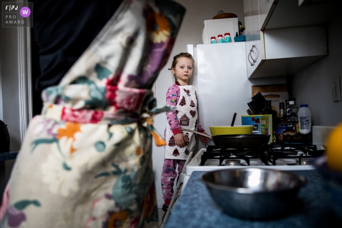 Photo by: <a href="https://www.fpja.com/documentary-family-photography-contests/anabel-burin/montreal/2112094">Anabel Burin - Canada</a> Moment driven Montreal family photojournalism image of a single mother and her daughter on their Saturday tradition of cooking banana pancakes for breakfast.