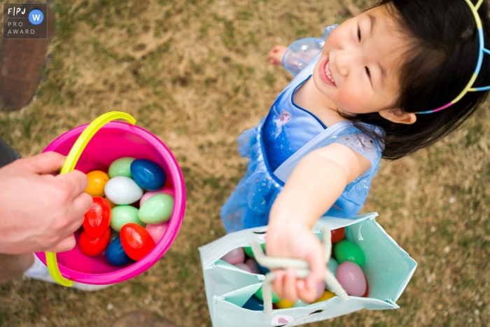 Moment-driven Atlanta family photography of a Girl showing off her Easter Egg collection 