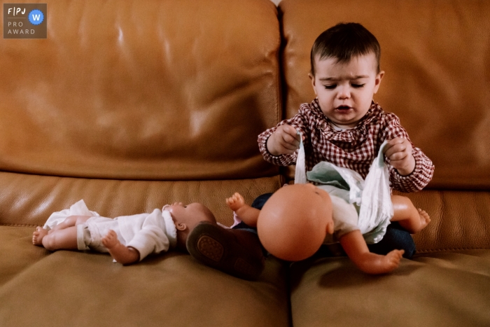 Moment-driven Paris family photography of a young child playing with dolls