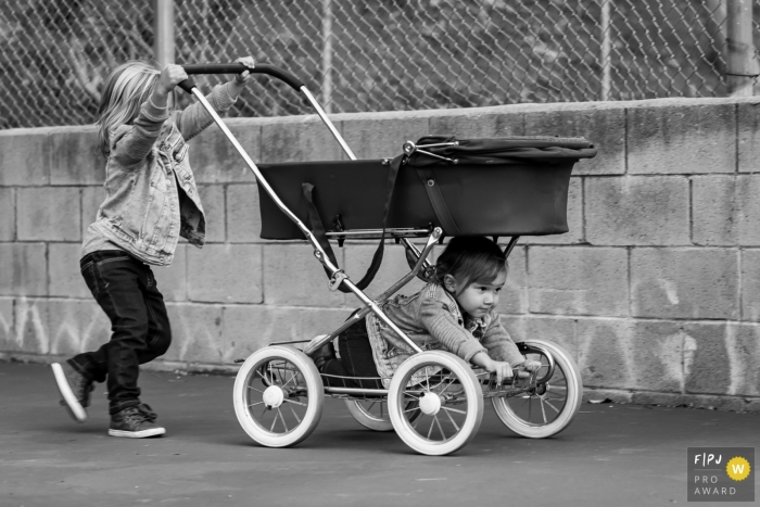 Moment-driven Ventura family photography of an older boy pushing old-school pram with little brother along for the ride Moment-driven Ventura family photography of an older boy pushing old-school pram with little brother along for the ride