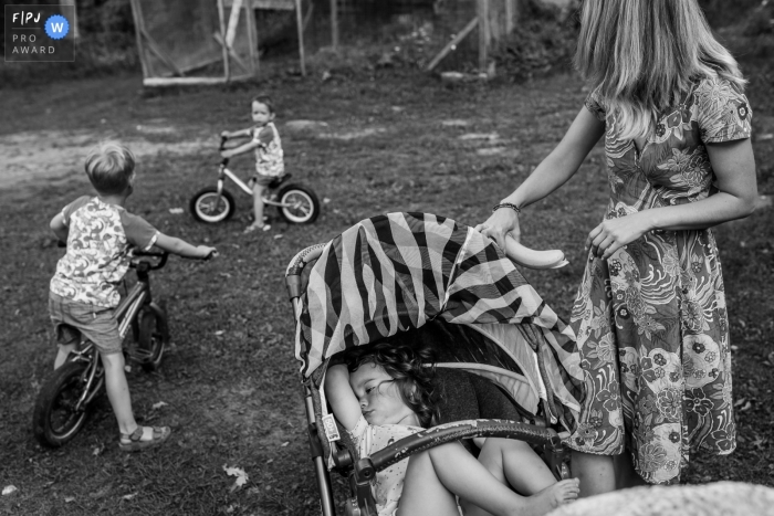 Moment-driven Tallinn family photography at home showing a moment while some child needs a play and the other needs some naptime