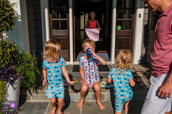 Moment driven San Francisco family photojournalism image from the porch at start of the day