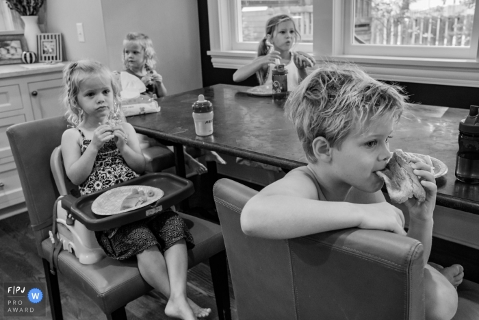 San Francisco family photojournalism image in BW around the kitchen table at Breakfast time Moment driven San Francisco family photojournalism image in BW around the kitchen table at Breakfast time