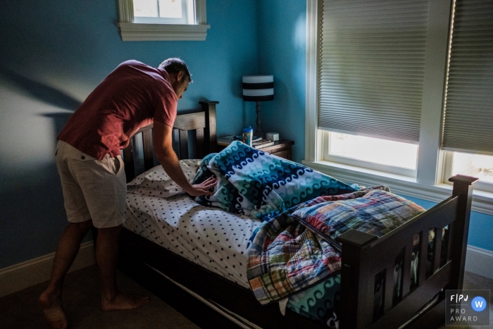 Moment driven San Francisco family photojournalism image showing dad suggesting its time to wake up