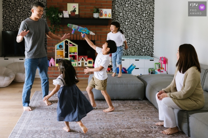 Moment-driven Los Angeles family photography showing an Asian family playing in the playroom Moment-driven Los Angeles family photography showing an Asian family playing in the playroom