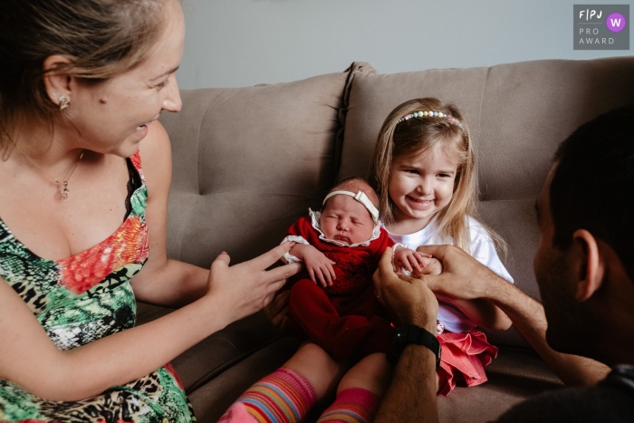 Moment-driven Santa Catarina family photography showing the Baby coming home and finding a big sister