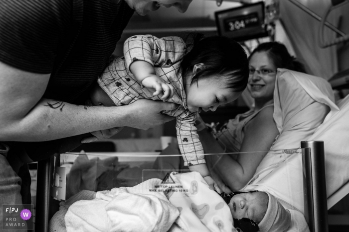 Martini Ziekenhuis birth photo with a proud sibling reaching out to her new family member