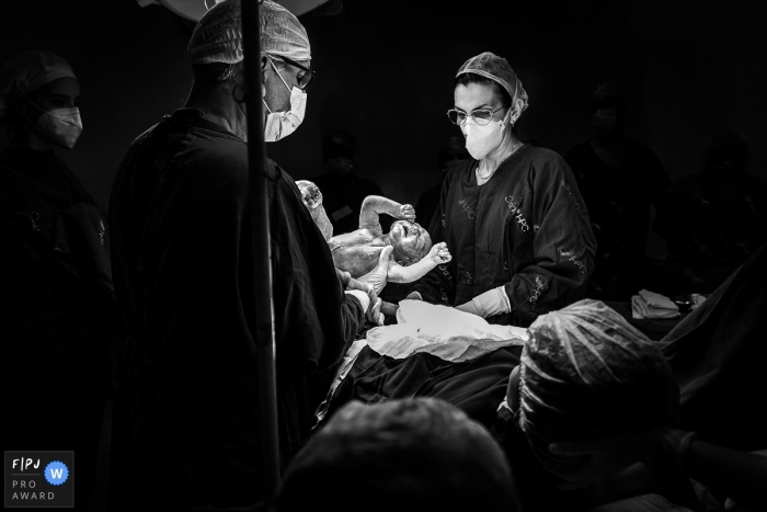 Hospital Plantadores de Cana birth photo in black and white of the baby emerging from the mother