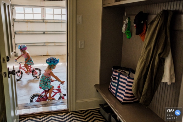 San Francisco day in the life photo of twins riding bikes in the garage San Francisco day in the life photo of twins riding bikes in the garage
