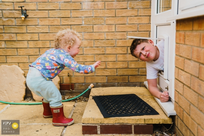 Norfolk family photo of a young boy stuck in the dog door flap Norfolk family photo of a young boy stuck in the dog door flap