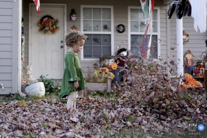 Joplin family photo session of a young girl playng in the leaves