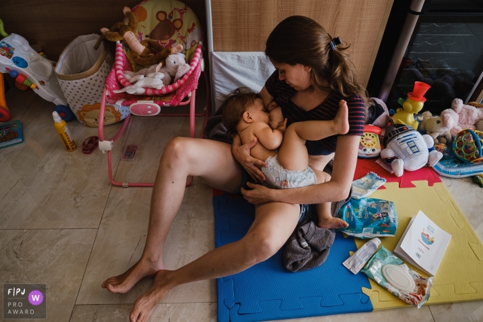 Sao Paulo day in the life photo of a mother nursing her child in the playroom Sao Paulo day in the life photo of a mother nursing her child in the playroom