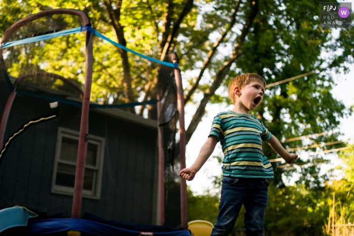 Atlanta at-home session image of a boy as he dances and sings in the backyard 