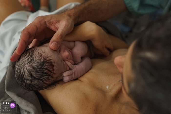 Photo by: <a href="https://www.fpja.com/documentary-family-photography-contests/raquel-o%E2%80%99czerny/sao-paulo/2115491">Raquel O’Czerny - Brazil</a> A Sao Paulo documentary birth photographer captured mom and dad hands touching new baby