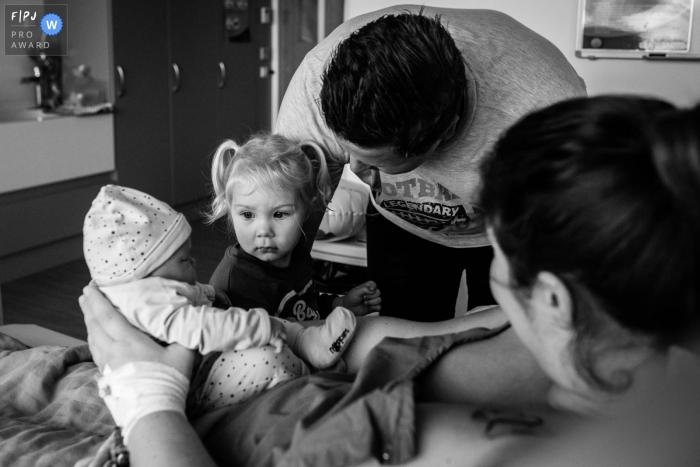 A Groningen documentary family photographer captured this big sister asking Who is this little human