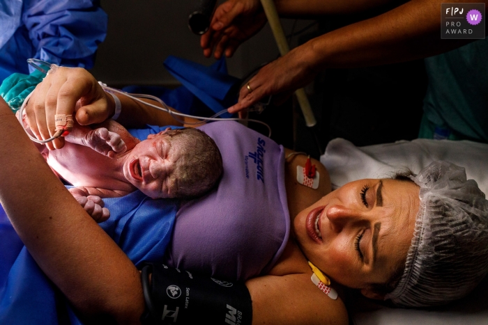 Photo by: <a href="https://www.fpja.com/documentary-family-photography-contests/priscilla-mondo/sao-paulo/2116373">Priscilla Mondo - Brazil</a> A Sao Paulo, Brazil documentary birth photographer at São Luiz Itaim captured this baby boy on the tummy of mommy at the hospital