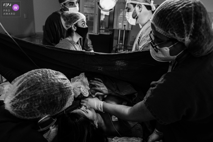 A Sao Paulo documentary birth photographer captured this image in BW showing the hospital crew and supportive Team Work A Sao Paulo documentary birth photographer captured this image in BW showing the hospital crew and supportive Team Work